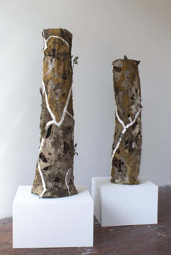 Joella Gardner - BA Fine Art work by Joella Gardner showing two column sculptures. Bold white lines wind around the textured surface of the columns, which are various earthly tones.