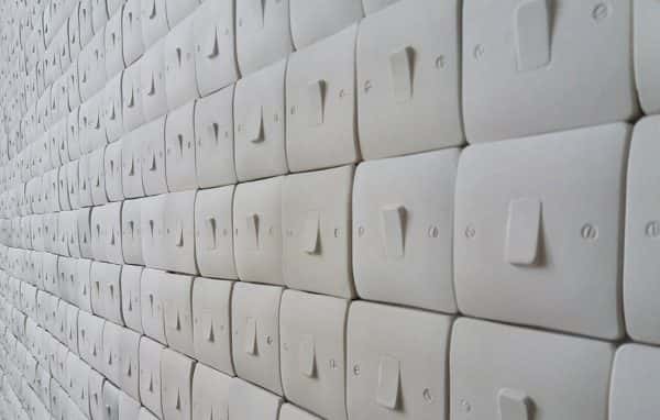  - image shows long wall of seemingly infinite light switches of the same type with no spacing and set randomly