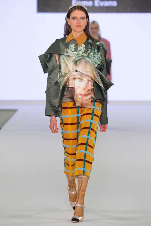 Esme Evans - Image a female model wearing a garment with the queens face on and yellow checked trousers