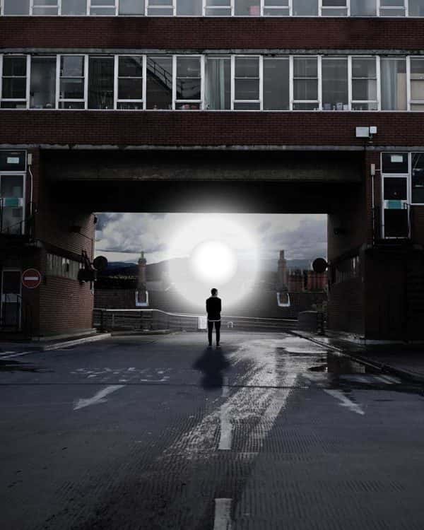 Fahim Fadzlishah - Image of a person standing below a bridge with a light orb standing