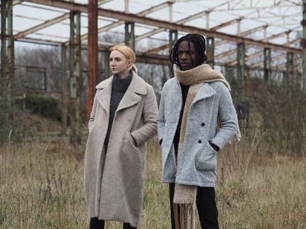 Olivia Harrould - Image of two models standing in a field wearing winter jackets and staring off in the distance
