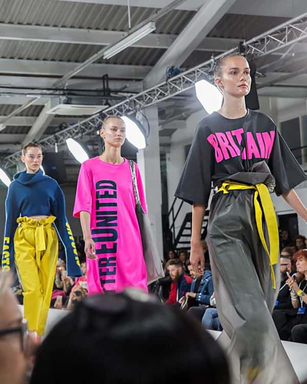 Meg Tovey - Image of three models walking down a catwalk wearing clothes design by NUA Fashion student Meg Tovey
