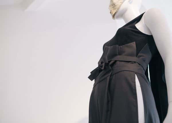 Uzair Khan - Image of the detail of a tailored garment featuring grey trousers and a black top