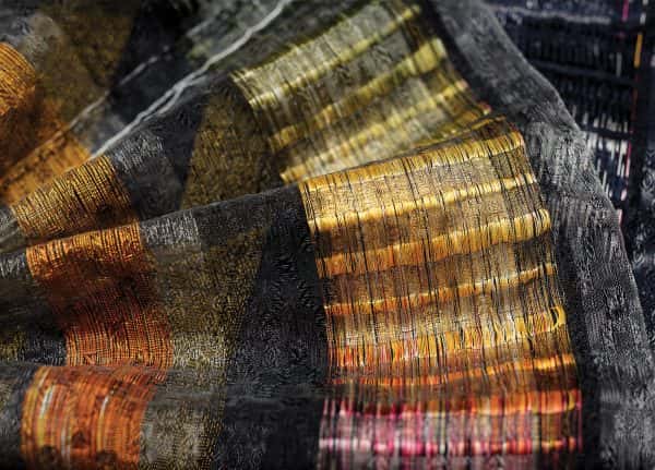 Bethany Franks - Image of embrodiered material featuring the colours grey, yellow, orange and red