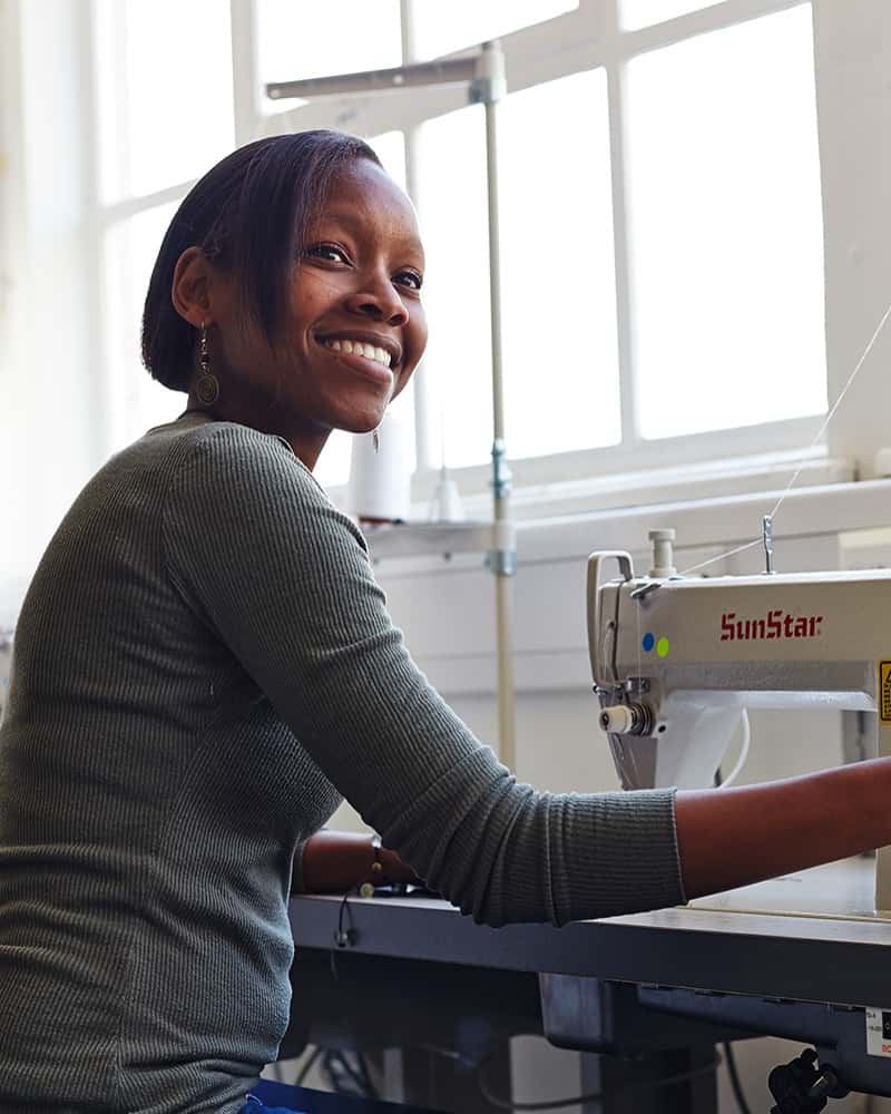 Naomi Wambugu MA Fashion student at sewing machine in Fashion Workshop