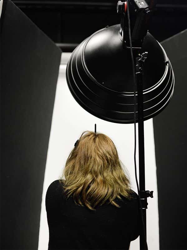  - Image of a student shooting in the Photography studio