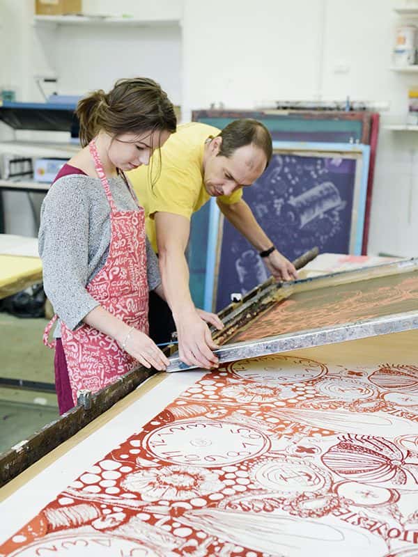  - Image of a student and a turor looking at a textiles screen
