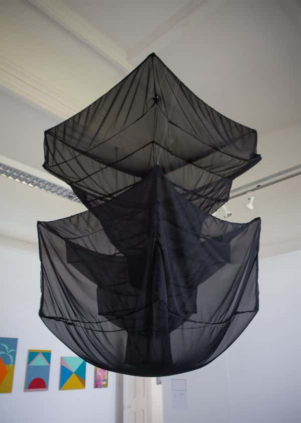  - Photograph of large geometric black mesh sculpture hanging from ceiling in BA Degree Show 2017