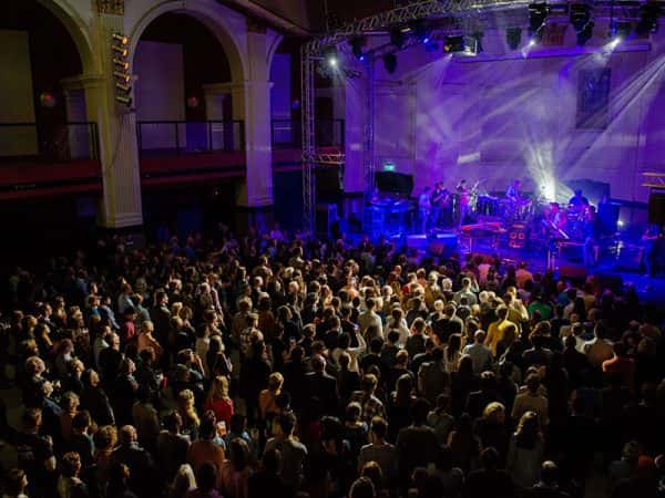 Open Live Music Venue - Image of an audience from an ariel view watching a band in a large music venue