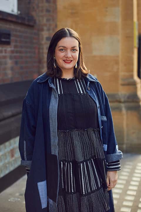 Susie Lloyd, BA Fashion Communication and Promotion Lecturer standing outside St Georges Building, Norwich University of the Arts