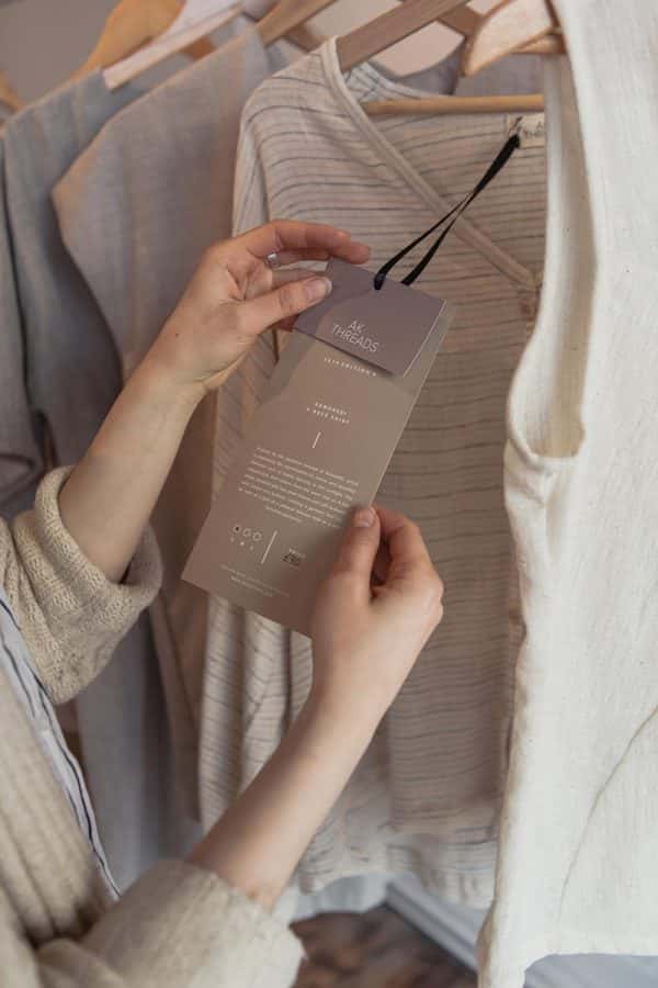 Marta Zaremba - Person holding a tag of a clothing designed by BA Fashion Communication and Promotion student Marta Zaremba