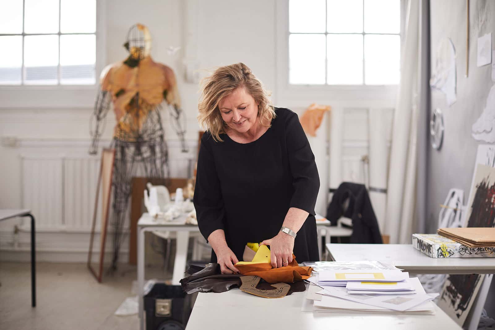 Marie Brennan works on her shoemaking business in the NUA MA Fine Art studio in front of art