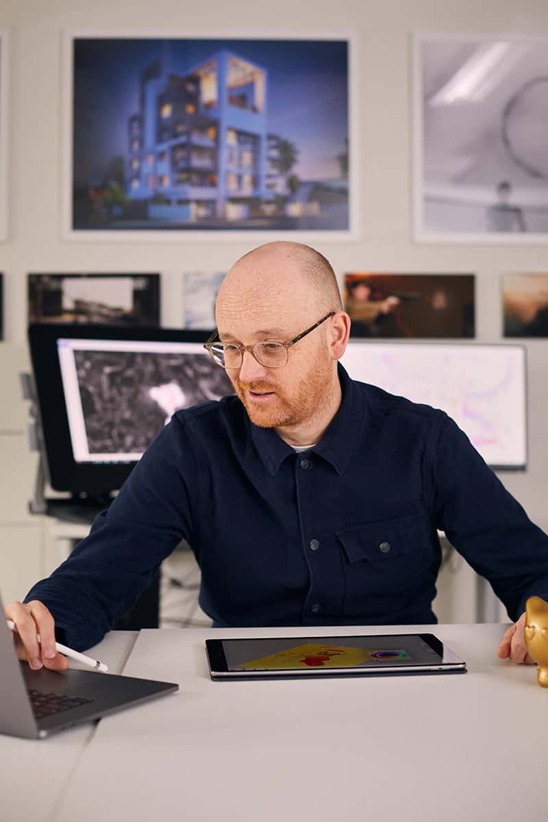 BA Animation Lecturer Jon Dunleavy sits in front of a computer, a cintix designing animations