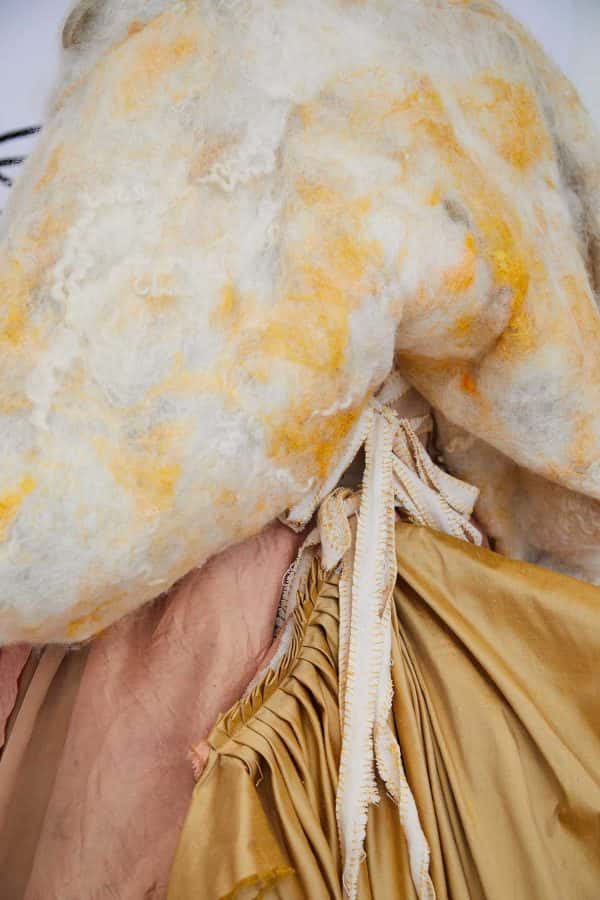 Libby Double - Close up of a garment on a mannequin with different textures in soft yellow, pink and cream