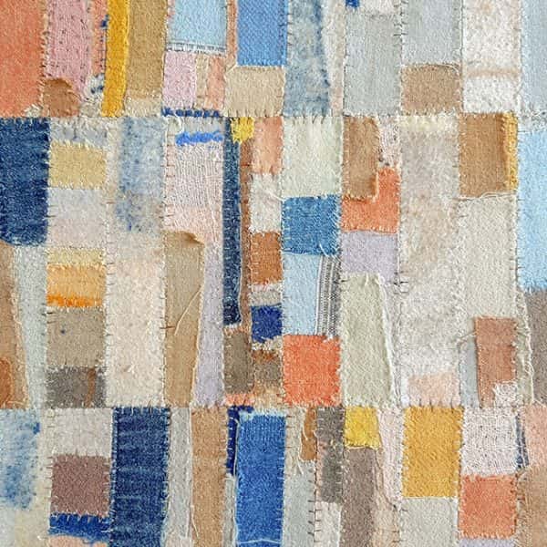 Lucie Summers - Square artwork in blues, yellows, oranges and creams made up of different sized square and rectangular pieces of fabric
