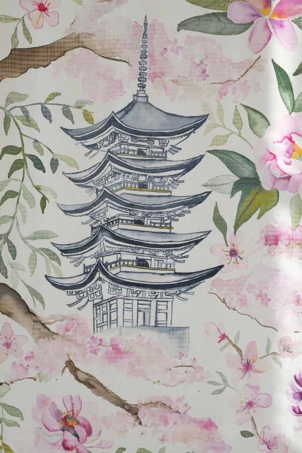 Daisy Gyapong - Close up of a printed piece of silk showing a Japanese tiered building surrounded by green leaves and pink flowers