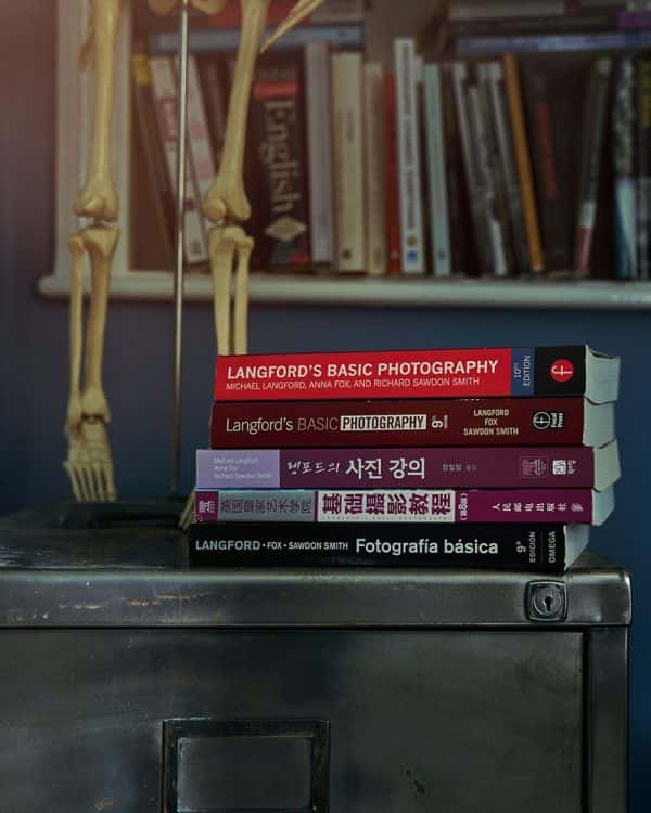 Books by Professor Richard Sawdon Smith - 5 books on top of a metal filing cabinet. There are three books in a different language but the top two are called 'Langford's basic photography'