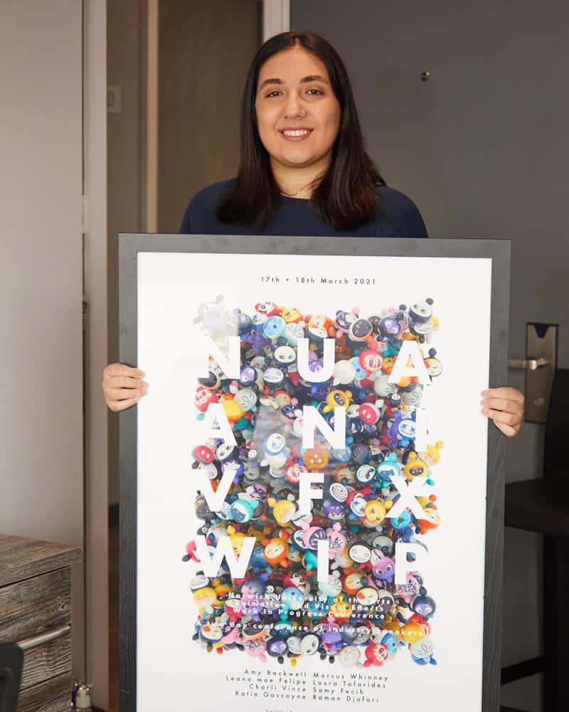 person holding a framed animation and vfx poster 2021