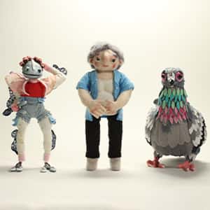 Three fabric stop-motion puppets, of a humanoid amphibian, grandmother, and life-size pigeon, by Daisy Crockford